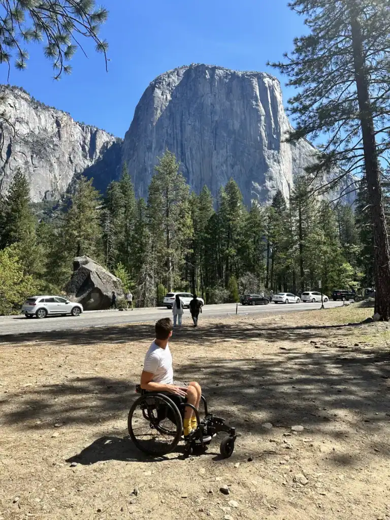 Dean in his wheelchair with El Capitan towering above Yosemite Valley